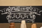 A series of chalk boards behind the counter provide info.. This reminds you where you are.
