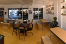 A panoramic view of the seating in the front half of Siop Shop from beside the counter.