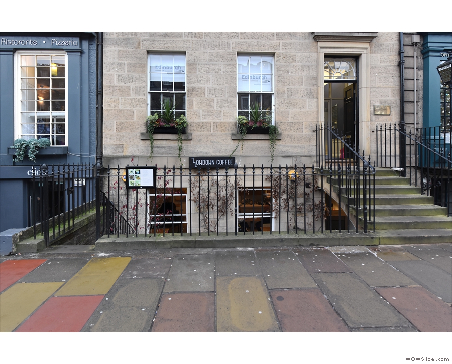 On George Street, in Edinburgh, iron railings fence off...