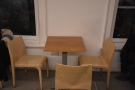 ... and one of the three-person tables against the front wall.
