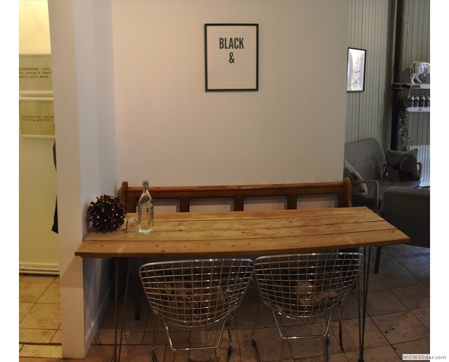 This four-person table, complete with bench, is against the right-hand wall...