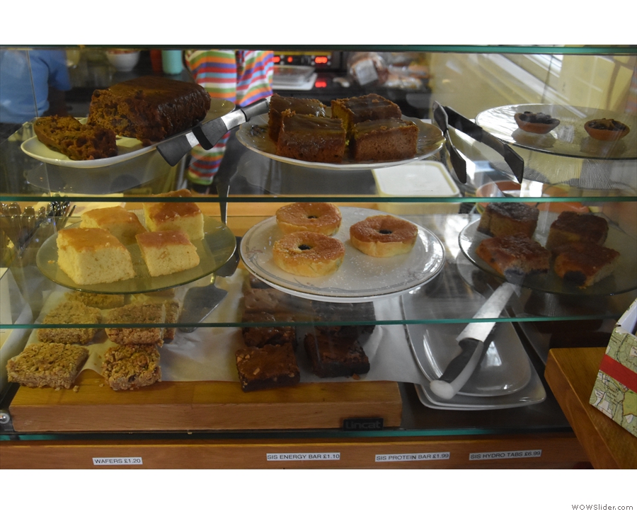 ... and the cakes on the right, with an open kitchen behind the counter...