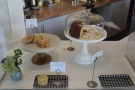 There is a selection of cake just to the left of the till, ahead of you as you enter...