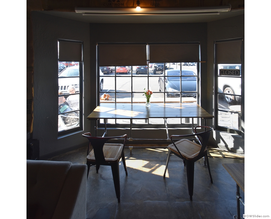 One of the best seats in the house is the two-person table in the window-bay...