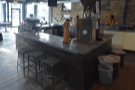 ... opposite the counter, where you'll also find three low bar stools along the side.