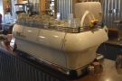 The white La Marzocco FB 80 espresso machine is at the far end of the counter.