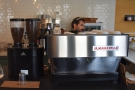 The espresso machine, and its twin-headed grinder, are off to the left.