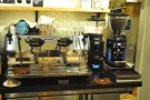 The epresso machine and its two grinders, seen here in 2016, are behind the coounter.