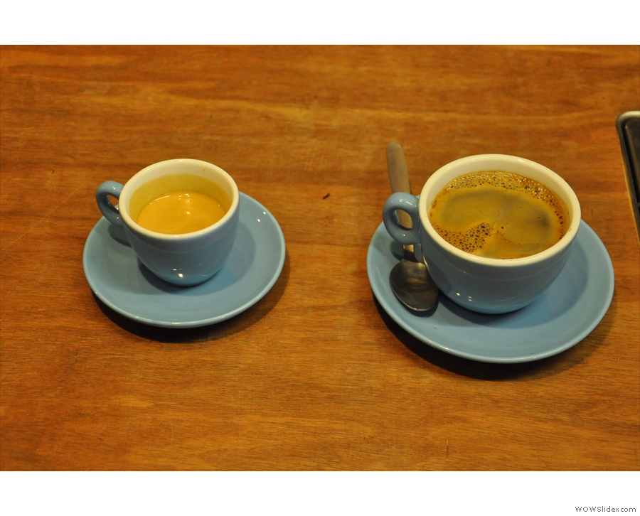 An espresso and an americano being prepared for other customers. I love the blue cups.