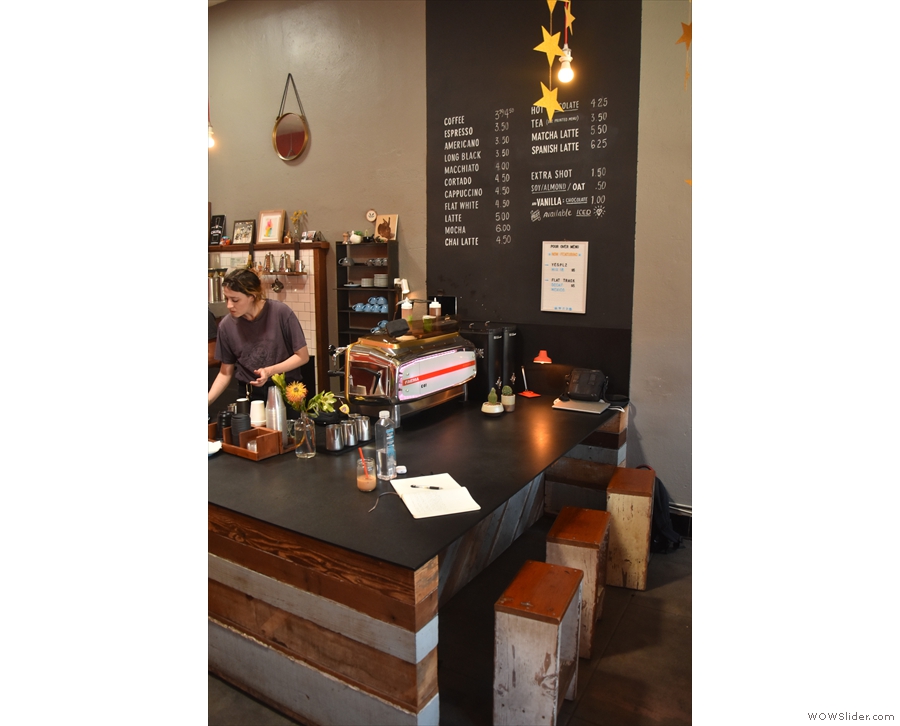 You can sit at one of three stools at the front of the counter, by the espresso machine.