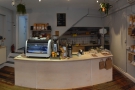 ... with cakes to the right, till in the middle & espresso machine + batch-brew on the left.