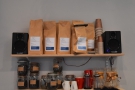 ... with bags of the current coffee on the shelves above.