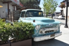 There's an old Chevy truck parked on the corner of San Pedro and Saint John Streets.