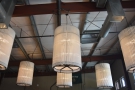 Meanwhile these vertical cylindrical bundles hang at the bar end of the communal space.