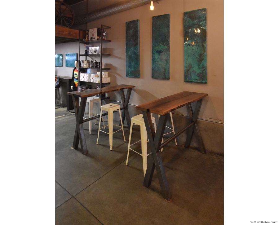 Like the one at the front, these are long, thin trestle tables with high, plastic stools...