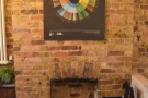 More art on the walls, this time the coffee tasting wheel above a fireplace at the back.