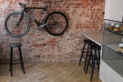 There's also a bicycle on the wall and, to the right of that, a pair of stools at the top...