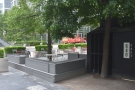The outside seating is on a slightly raised decking area, screened by planters.