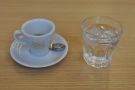 My espresso arrived in a Pumphrey's cup with a glass of water (without having to ask)