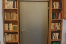 This neat bookshelf set-up frames a door in the back room...