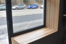 Immediately to the left of the left-hand door, the windowsill doubles as a bench.