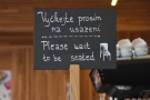 ... a handy sign telling you to wait to be seated in English as well as Czech.