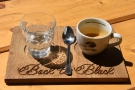 My espresso (the first of two) came served on a wooden tray, glass of water on the side.