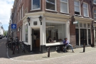 On a street corner in Amsterdam stands a bright, inviting space...