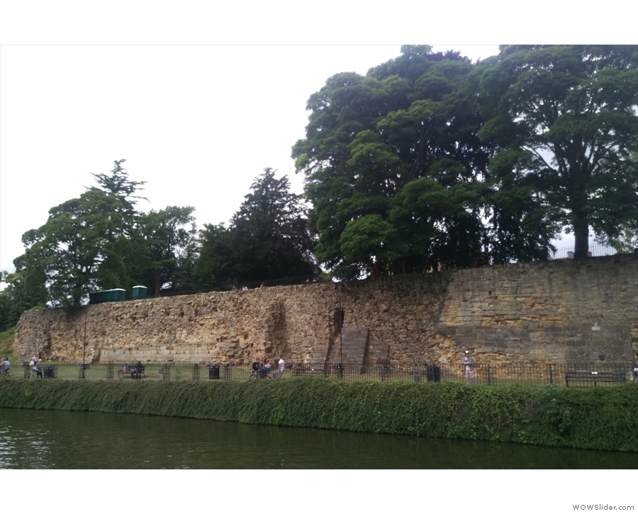 The massive southern curtain wall of Tonbridge Castle, seen from across the Medway.