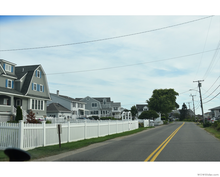 ... we reached a long stretch of road, with houses on either side, ocean to our left...