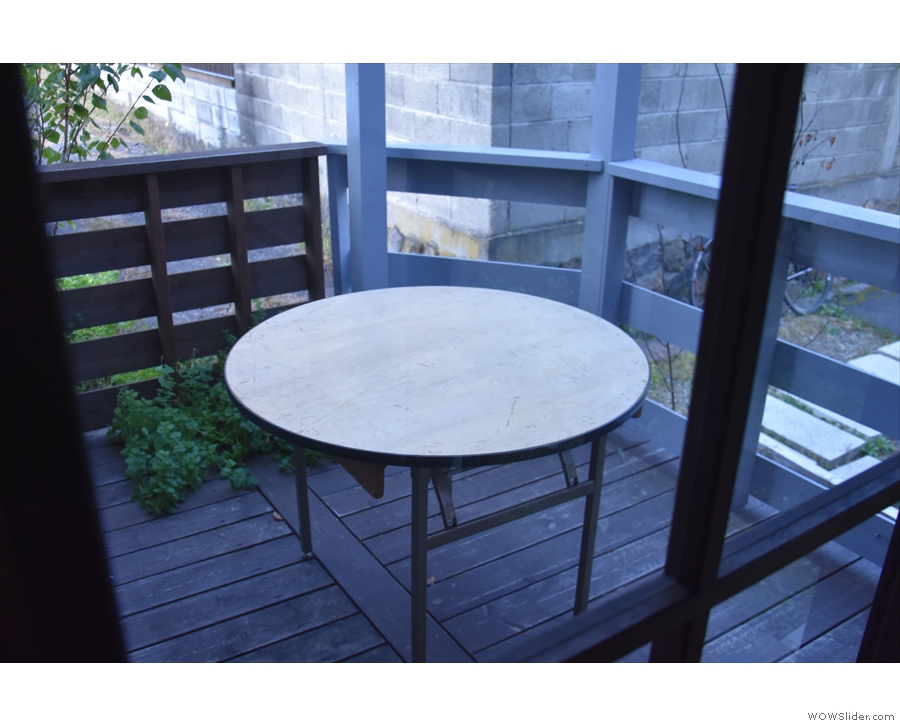 ... an enclosed porch with a single round table.