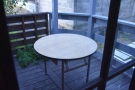 ... an enclosed porch with a single round table.