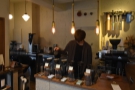 The counter, with its row of V60s and coffee beans in jars, is opposite the door.