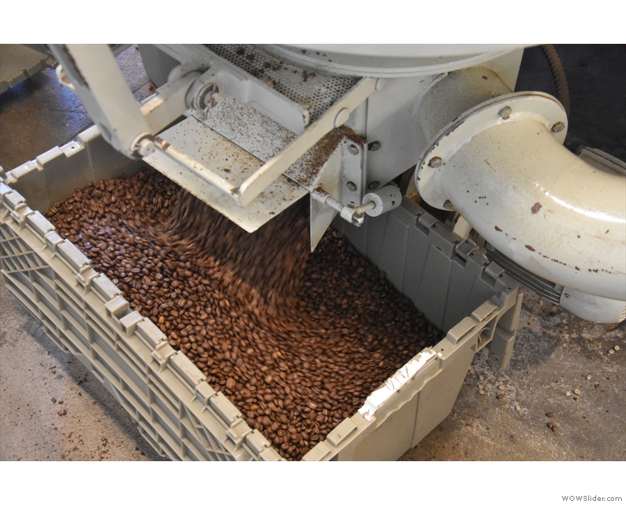 When the beans are cooled, they're deposited into a box from a chute at the bottom.