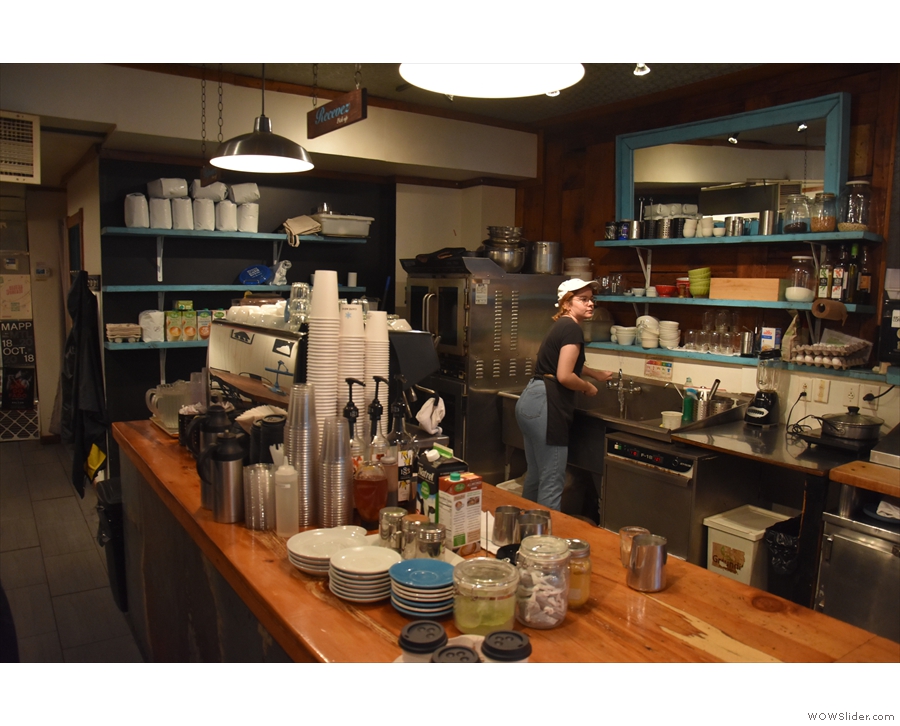 The counter runs down the Rue Rachel side of Café Névé, open kitchen behind it and...