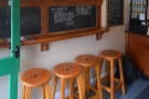 There's a row of four stools against a narrow bar against the left-hand wall...