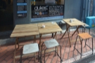 There's outdoor seating, with four of these two-person tables to either side of the door.