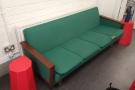 ... with a four-person green sofa against the left-hand wall.