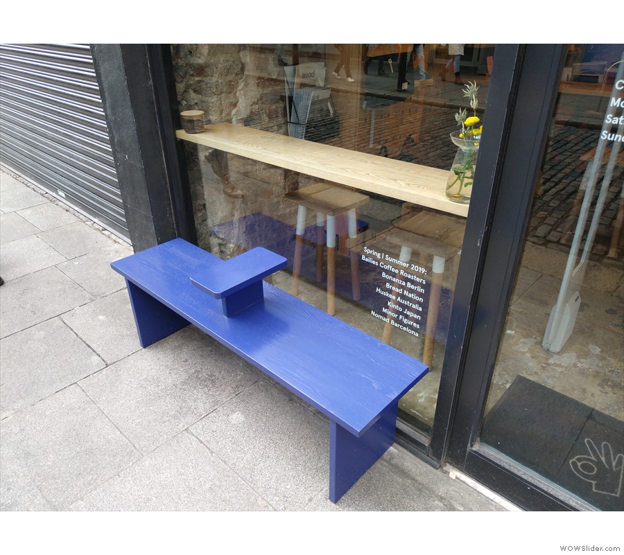 This neat bench, located to the left of the door, provides some outside seating.