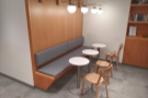 ... with three two-person tables lining a padded bench against the wall.
