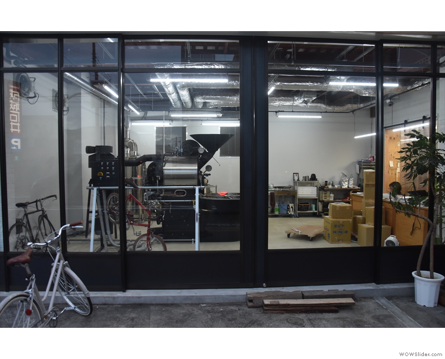 The new roaster, a 22 kg Probat, is clearly visible through the roastery windows...