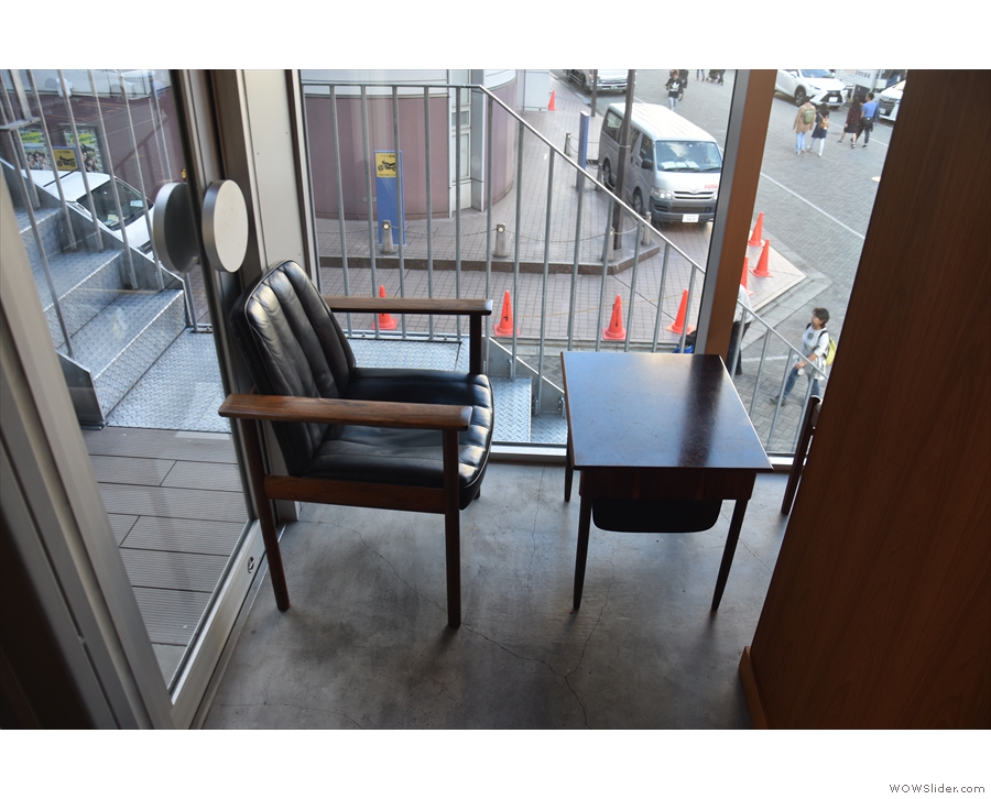 On the other side, there's still a single chair and table, but it's a dfferent one, while...