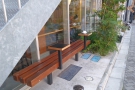 If you want to sit outside, there are plenty of benches like this, with in-built coffee tables.