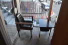 On the other side, there's still a single chair and table, but it's a dfferent one, while...
