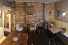 Finally, there's another two-person table against the exposed brick of the right-hand wall.