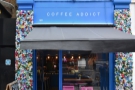 Coffee Addict, a small, striking space, with flower-decked walls & lighting to match