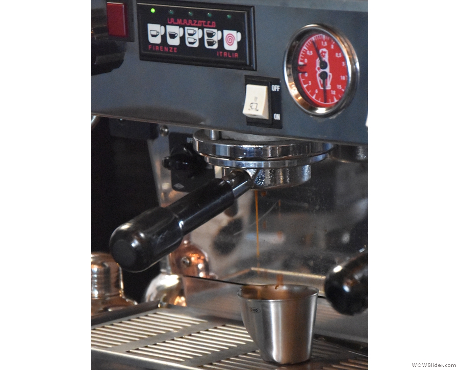 The espresso machine, at the back of the counter, is ideal for watching espresso extract...