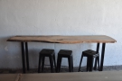 ... with a narrow, three-person table against the wall to the right.