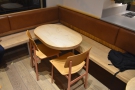 The L-shaped bench has four tables in all, including this oval one in the corner.