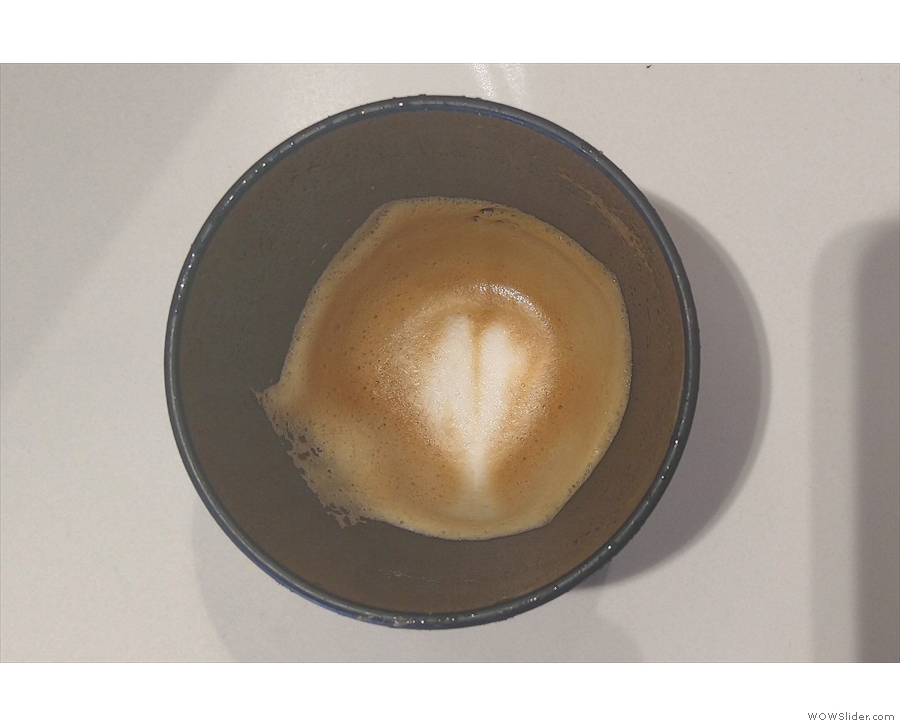 ... holding the latte art to the bottom of the cup.